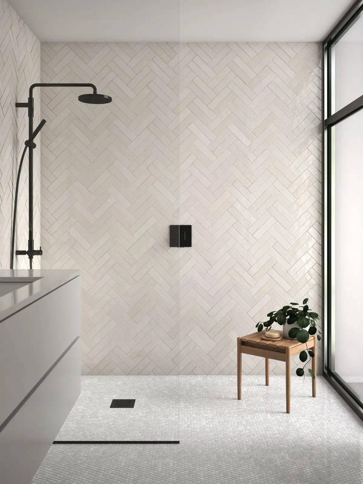 Beige herringbone ceramic tile backsplash in a warm kitchen with shaker cabinets and wood shelves