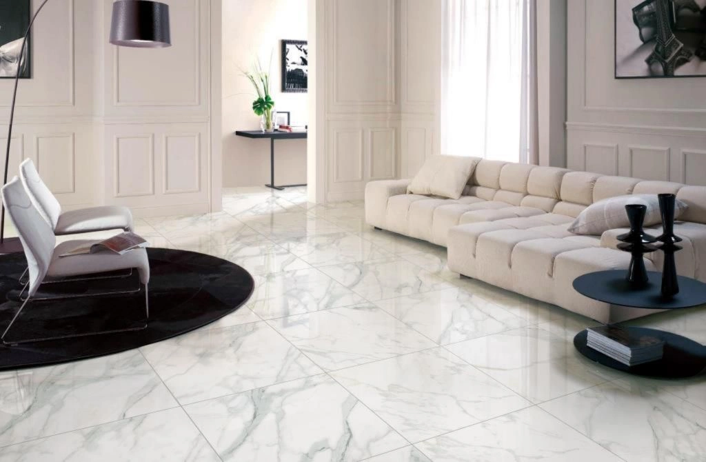 Glossy Calacatta marble-look porcelain floor tiles in a classic white-paneled living room